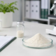 Lumbrokinase powder quality control lab setup with sample powder, documentation, and testing equipment