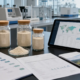 Earthworm peptide powder samples, quality documents, export carton, and sourcing dashboard in a modern laboratory workspace