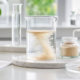 Earthworm peptide powder dispersing in water inside a laboratory beaker for solubility testing