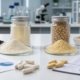 Lumbrokinase and nattokinase powder samples with specification sheets for B2B supplement ingredient comparison