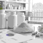 Private label lumbrokinase capsules with enzyme powder, capsule bottles, and quality documents in a lab workspace