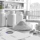Private label lumbrokinase capsules with enzyme powder, capsule bottles, and quality documents in a lab workspace