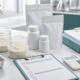 Lumbrokinase dosage claim review documents, lab scale, capsules, and quality checklist on a clean laboratory desk