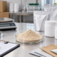 Earthworm peptide powder sample with blank OEM packaging, sample pouches, supplier documents, scale, and bulk cartons
