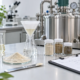 Earthworm peptide production setup with powder sample, filtration tools, quality documents, and stainless processing equipment