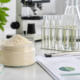 Lumbrokinase powder natural enzyme ingredient sample with laboratory testing glassware and quality documents