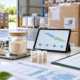Earthworm peptide bulk purchasing desk with powder samples, supplier documents, sealed cartons, and logistics planning tablet