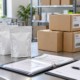 Conceptual ingredient dispatch table with sealed pouches, cartons, barcode scanner, batch documents, and clipboard for traceability checks