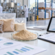 Earthworm protein powder sample with market outlook charts, supplier documents, and production planning materials